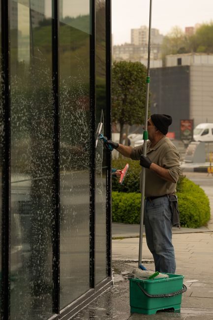 Laveur de vitres sur une façade vitrée professionnelle